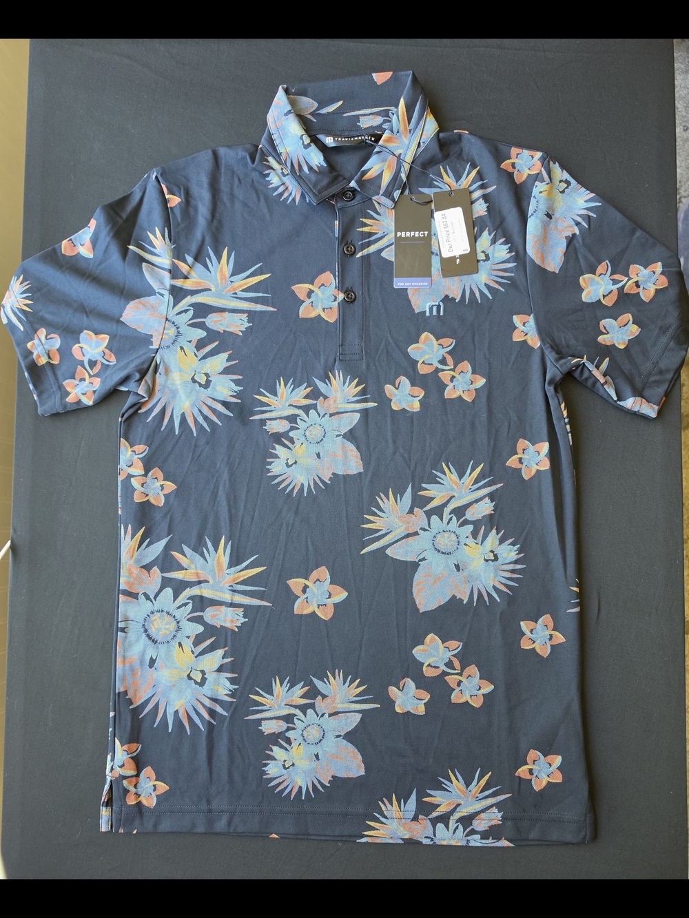 Travis Mathew Black Floral Polo with Orange Accents